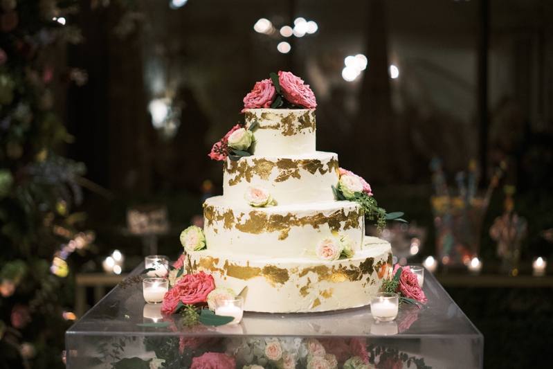 Four tiered wedding cake with gold foil