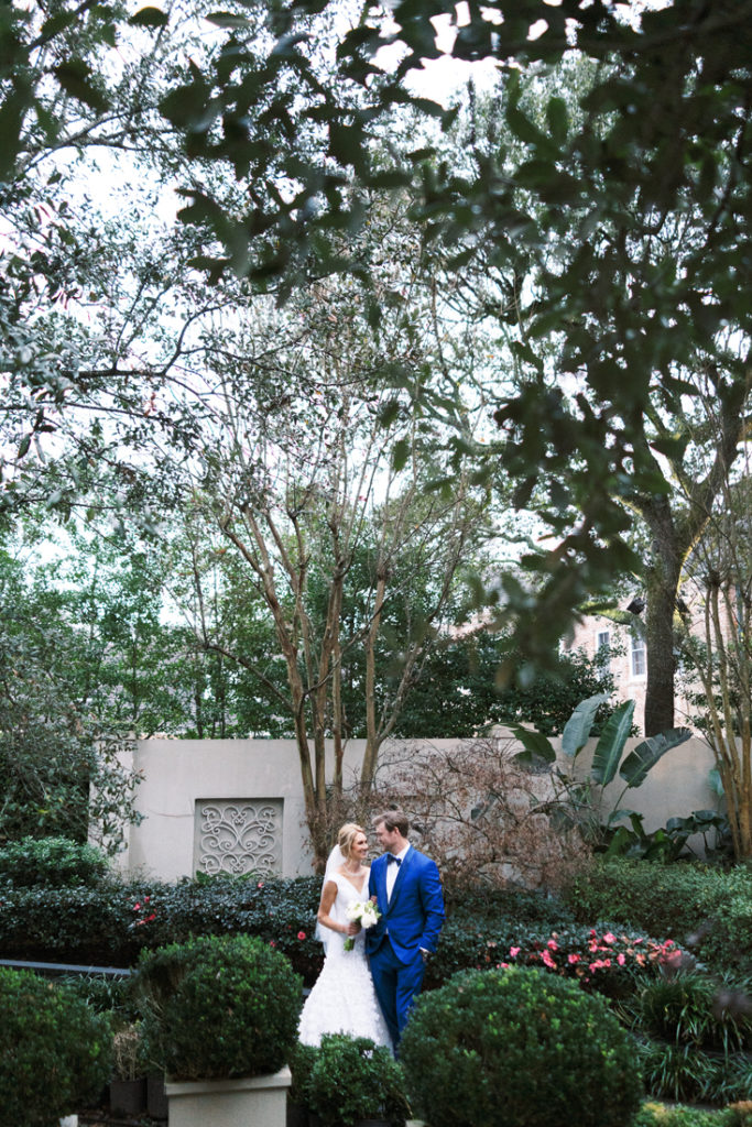 Bride and groom standing in middle of garden
