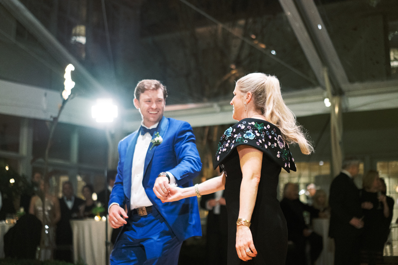 Groom and mother on dance floor at wedding reception.