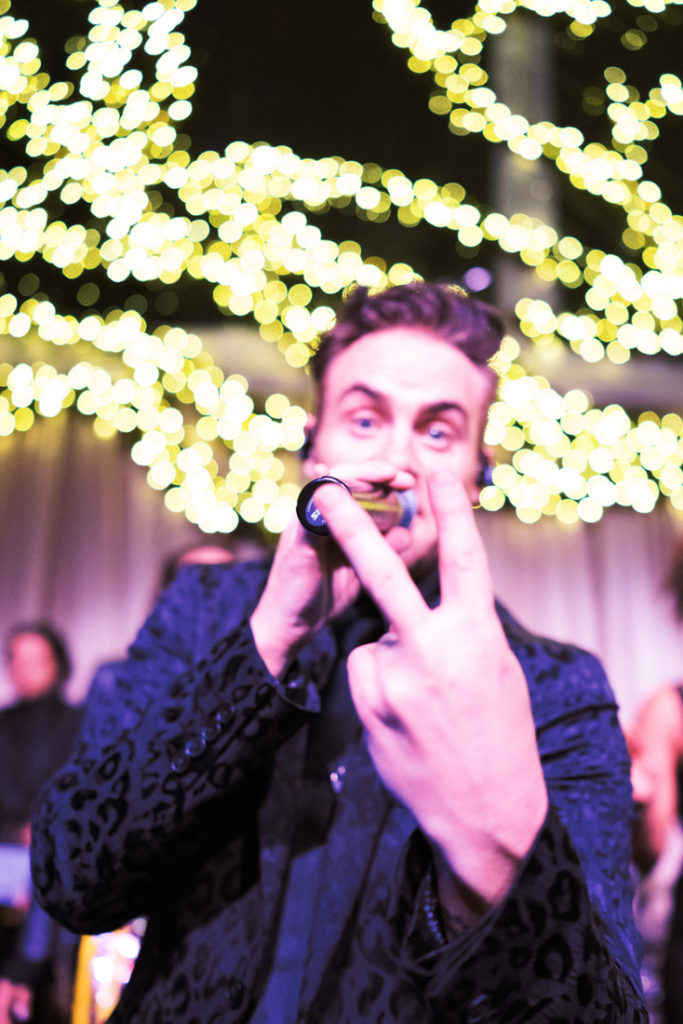 Vocalist for wedding band, Powerhouse, performing at a tented wedding reception in New Orleans.
