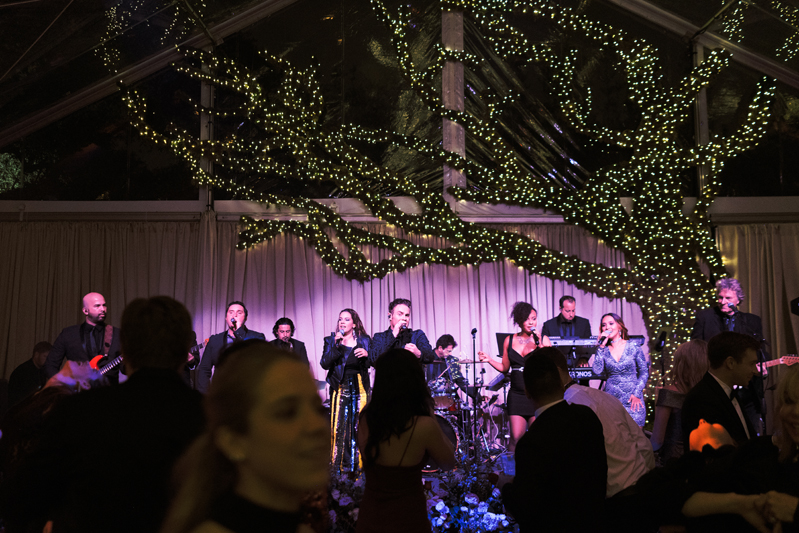 Powerhouse band and crowded dance floor during New Orleans wedding.