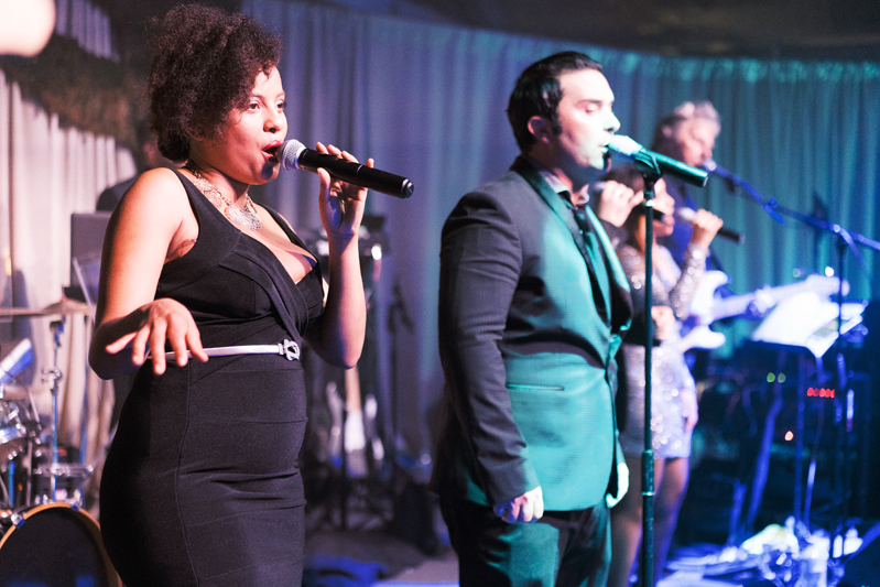 Powerhouse band vocalists performing on stage during Nola wedding reception.