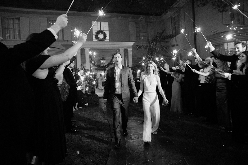 Bride and groom exiting wedding reception to sparklers.