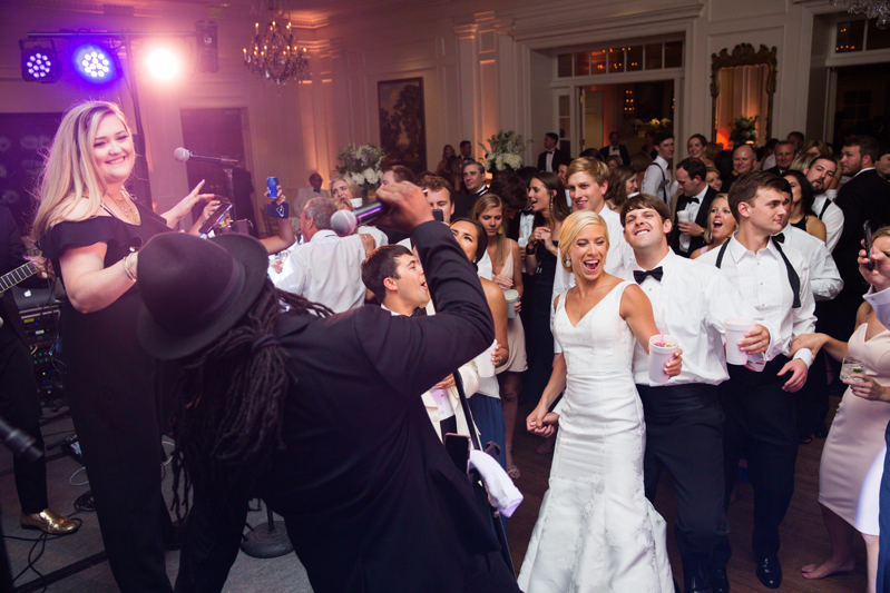 Bride and Groom dancing in front of Punch band at wedding.