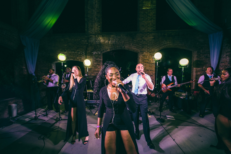 band members on stage during wedding reception performance