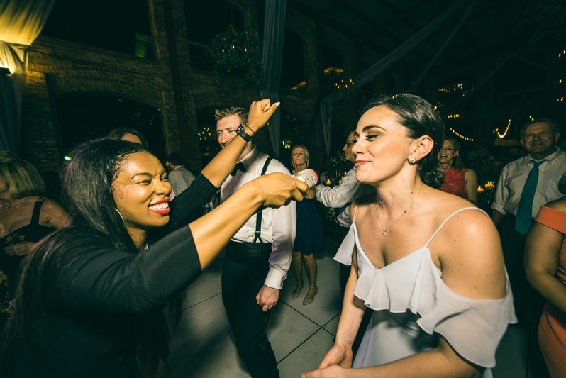 lead singer holding microphone to dancing bridesmaid