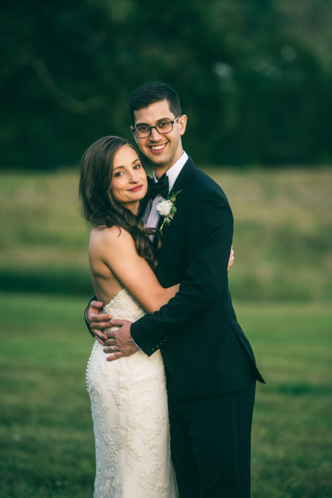 Bride and groom embracing at Summerfield Farms.