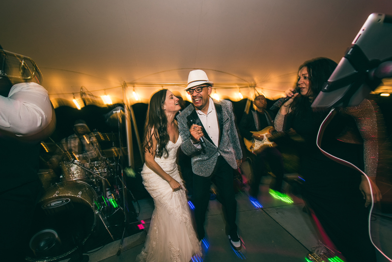 Bride singing on stage with Right to Party band at Summerfield Farms wedding.