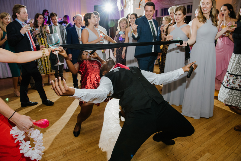 Guest on dance floor doing the limbo at Roaring Gap Club wedding.