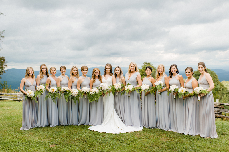 Bride and bridesmaids posing in a line at Roaring Gap Club wedding.