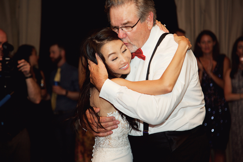 Father kissing daughter while dancing to Loose Chain wedding band.