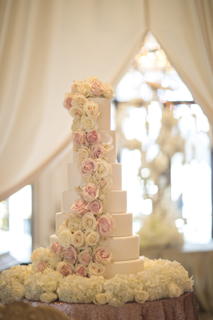 Six tier wedding cake with white and pink flowers