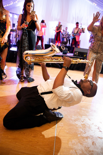 Sax player on dance floor during wedding reception at Biltmore Estate.