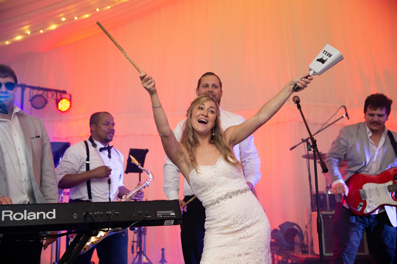 Bride on stage with Bantum Rooster band at Biltmore wedding reception.