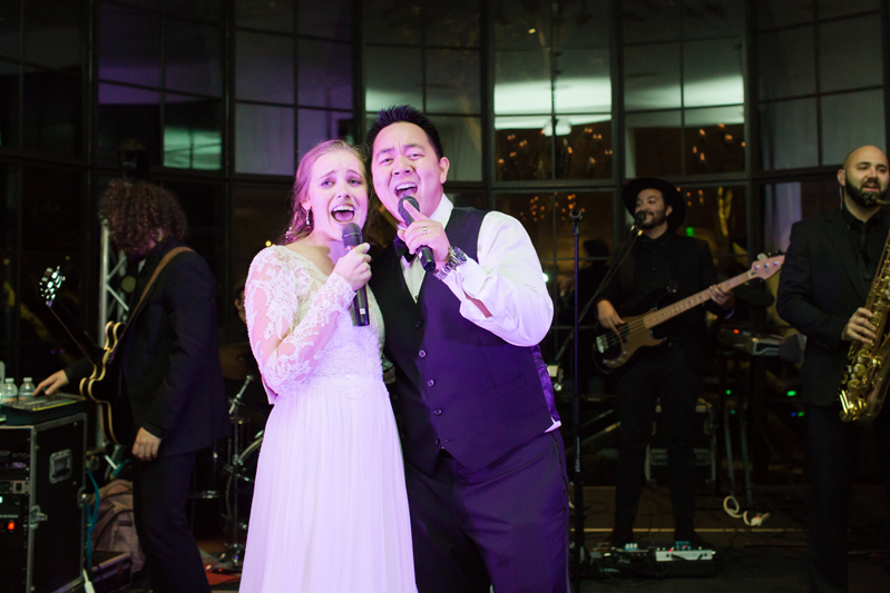 Bride and groom on stage with The Royals band during Kiawah Island Club wedding reception.