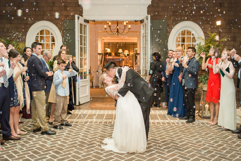 Bride and groom kissing as they make a grand exit from their Kiawah Island Club wedding.