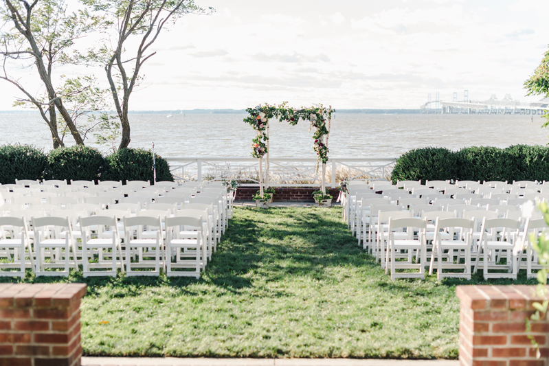 Waterfront wedding ceremony setup at Bride and groom dancing The Hora at Jewish wedding at Chesapeake Bay Beach Club wedding.