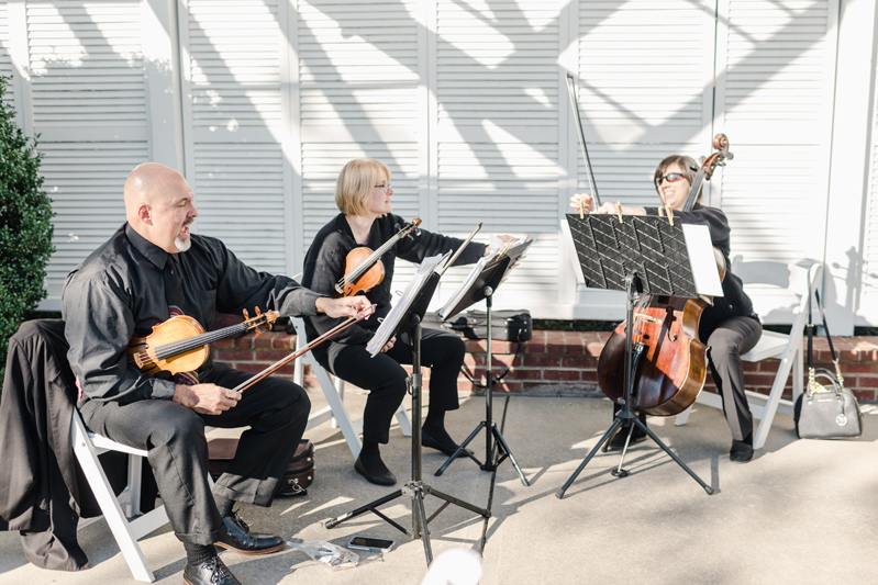String trio musicians performing at Bride and groom dancing The Hora at Jewish wedding at Chesapeake Bay Beach Club wedding.