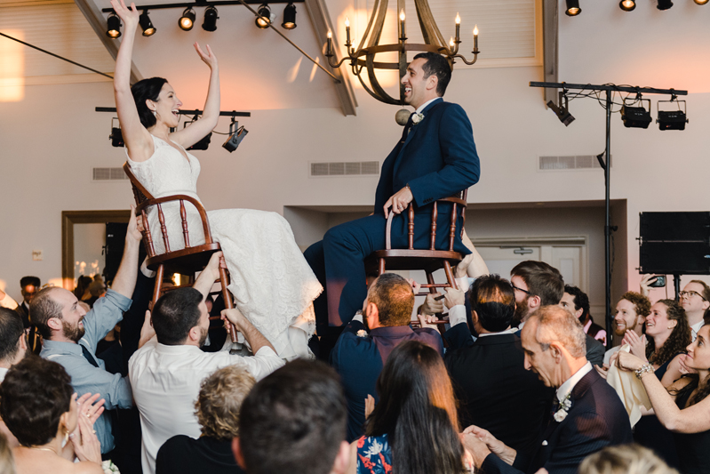 Bride and groom dancing The Hora at Jewish wedding at Chesapeake Bay Beach Club.