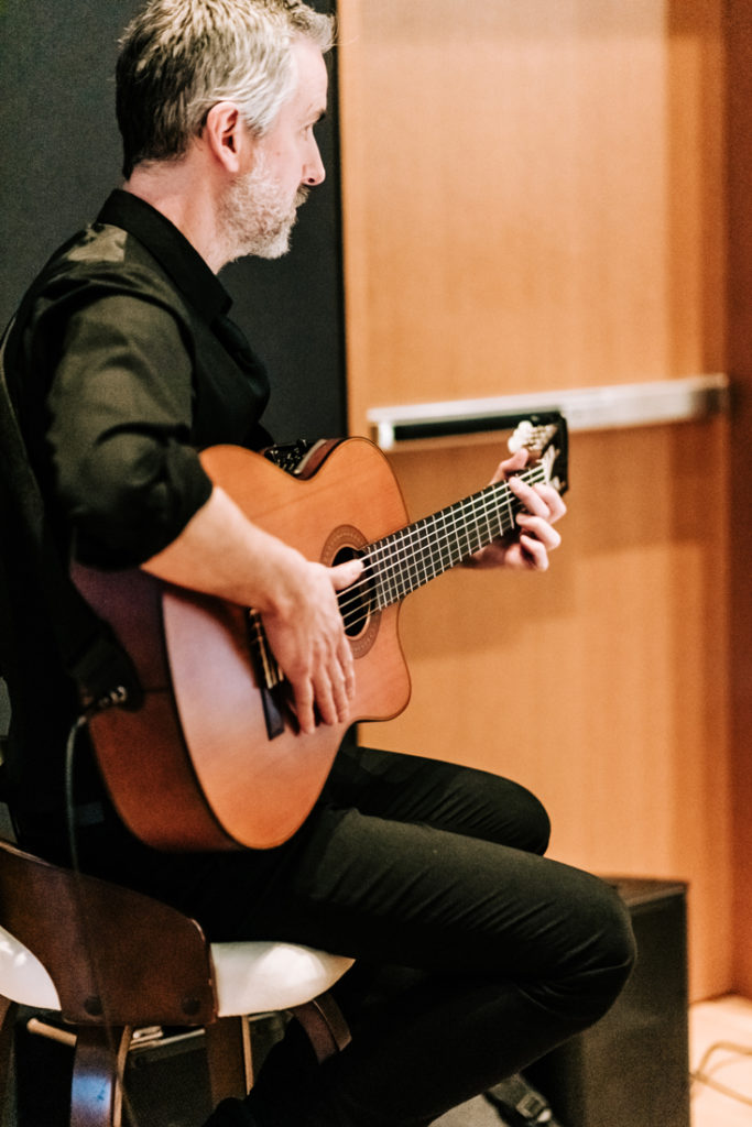 Solo guitarist playing during wedding ceremony at the Mint Museum uptown. 