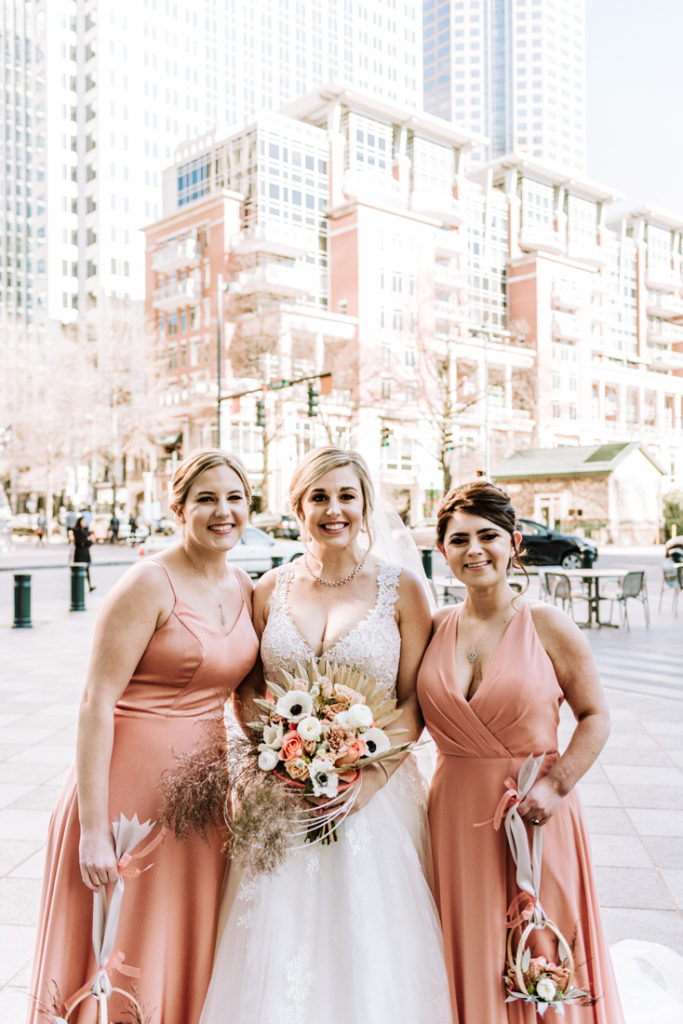 Bride and bridesmaids during uptown Charlotte wedding.