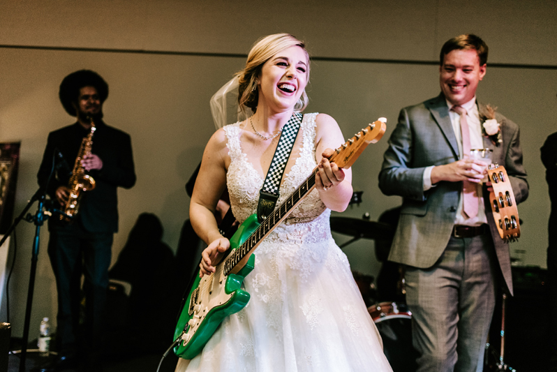Bride playing guitar with the Swingin' Richards wedding band in Charlotte, NC.
