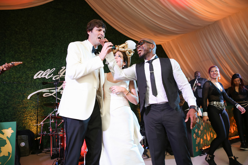 Bride and groom on stage with Simply Irresistible band