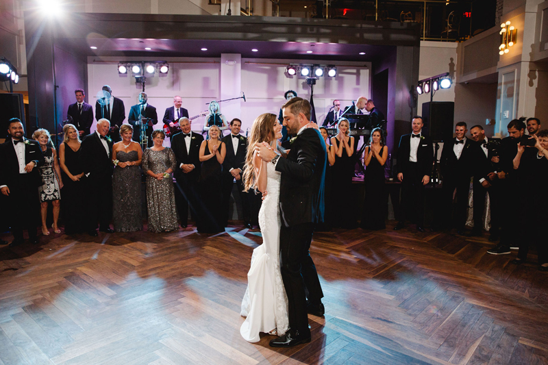 Bride and groom dancing first dance in front of Legacy band during Philadelphia wedding at The Lucy