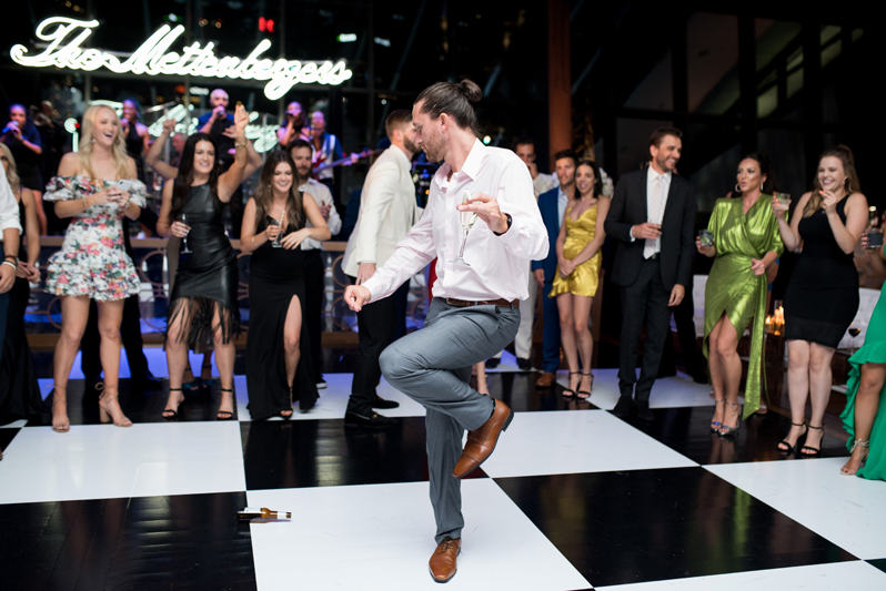 Guy dancing on black and white dance floor at Nashville wedding.