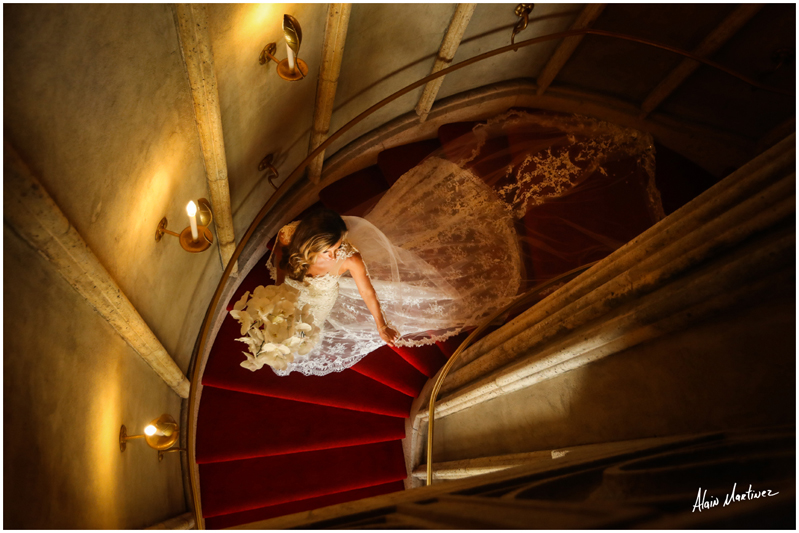 Bride walking down spiraled staircase at Mar-a-Lago