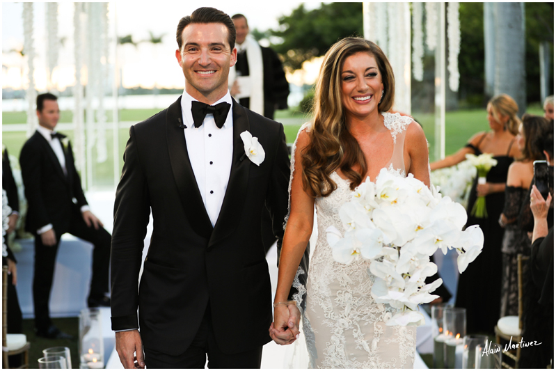 Bride and groom exiting wedding ceremony at Palm Beach wedding.