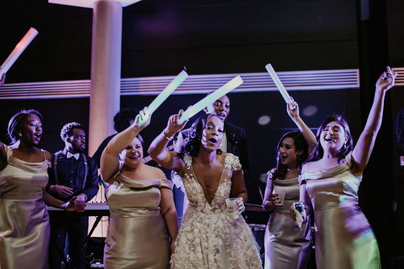 Bride on stage with Gentlemen & Their Lady a the Science Museum of Virginia wedding reception